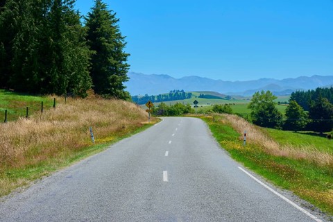 Rural road lined with trees with views of distant mountains, Geraldine Fairlie Lookout, Geraldine,