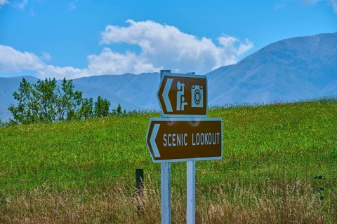 Scenic Lookout sign with photo camera icon against green mountain landscape, Geraldine Fairlie