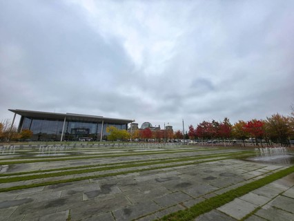 Extensive square with water fountains in the government district under heavy cloud cover in the