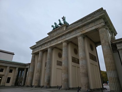The Brandenburg Gate, landmark of the city of Berlin, in front of cloudy skies, government district