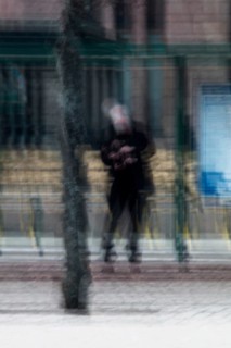 Abstract of a man waiting for bus under bus stop shelter captured using ICM intentional camera