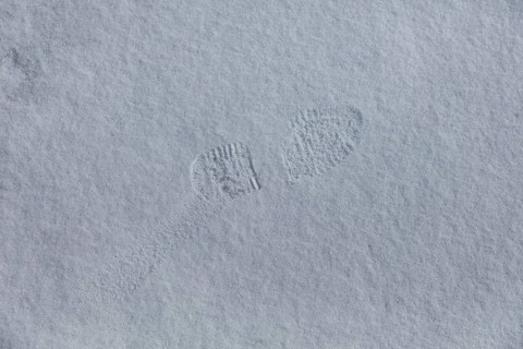 Closeup of boot footprint in snow in spring, Suomusjärvi kirkonkylä, Finland