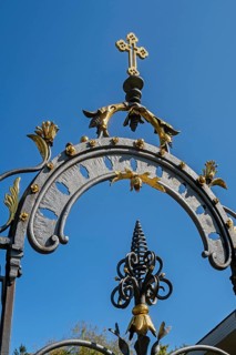 Blue sky and wrought iron gate to the cemetery in Maria-Thann, Allgäu, Swabia, Bavaria, Germany