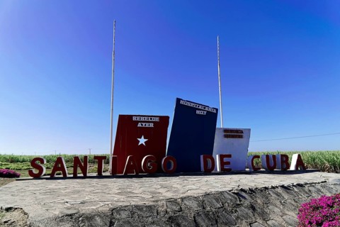 Blue sky sign 'Santiago de Cuba' in front of the countryside, Cuba, Greater Antilles, Caribbean,