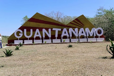 Large sign with 'Guantánamo' in a meadow surrounded by nature, Cuba, Greater Antilles, Caribbean,