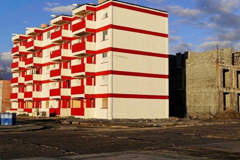 Baracoa, Cuba, Central America, modern high-rise building with eye-catching red and white color