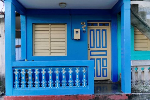 Baracoa, Cuba, Central America, Blue House with pastel colored doors, modern balcony and closed