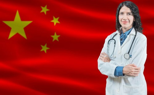 Chinese medicine and healthcare concept. Close up of doctor against China flag background