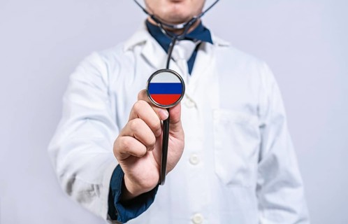 Doctor hands holding stethoscope with Russia flag. Russia health and care concept