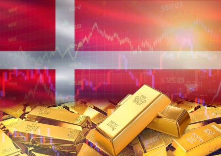 Gold bars on Denmark flag in background. Gold bars stacked on Danish flag. Concept of Denmark gold