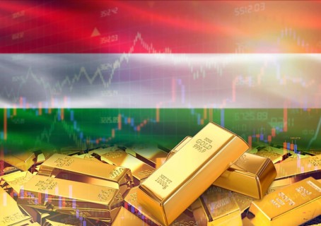 Gold bars on Hungary flag in background. Gold bars stacked on Hungarian flag. Concept of Hungary