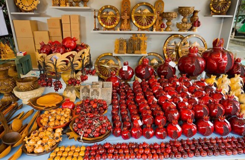 Selling red decorative pomegranate crafts on a market table, Vernissage Market, Handicraft Market,