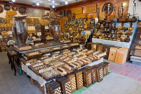 Shop with a variety of handmade wooden checkerboards and decorations, Vernissage Market, Craftsman
