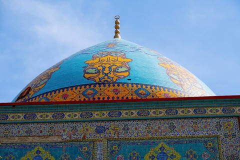 Detailed view of the richly decorated blue dome of a mosque with decorative ornaments, Blue Mosque,