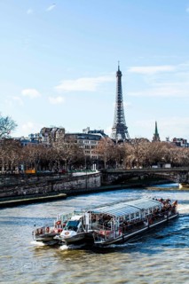 Tourist boat on Seine River viewed from Pont Alexandre III (Alexandre III Bridge) and Eiffel Tower