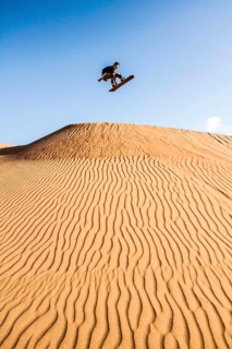 Sandboarding in Cerro Dragon, in Atacama Desert. Iquique, Tarapaca Region, Chile