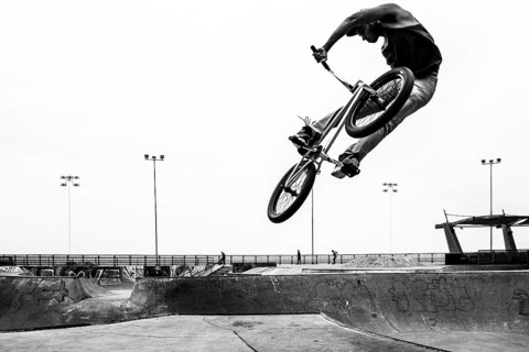 Young man jumping with a bicycle at Skatepark, in Playa Brava. Iquique, Tarapaca Region, Chile. 16