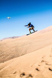 Sandboarding in Cerro Dragon, a sand dune located next to the city of Iquique, in Atacama Desert.
