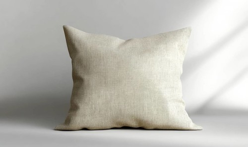 Beige cushion on a gray surface, displaying texture with soft natural light. AI generated