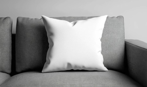White pillow on a textured gray sofa in a modern setting. AI generated