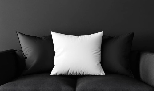 A modern black sofa with a white pillow in a minimalist setting. AI generated