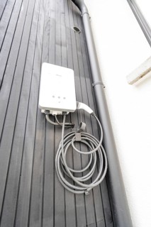 White wallbox on black wooden façade, house renovation, climate renovation, Metzingen, Germany