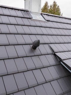 Roof detail with vent pipe on sealed fireplace area, house renovation, air conditioning renovation,