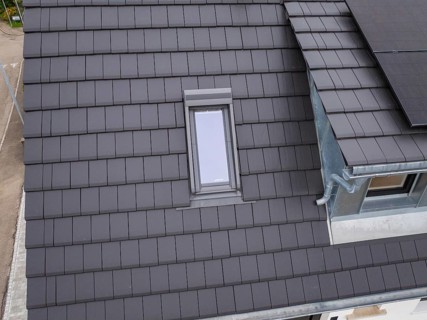 Detailed view of a roof with skylight near the gutter, house renovation, climate renovation,