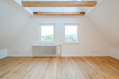 Two windows above a radiator with a view of the countryside in a quiet, bright room, house