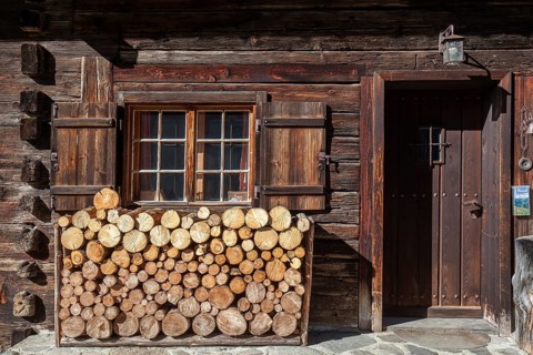 Sawn firewood in front of an old wooden house, Oberallgäu, Allgäu, Bavaria, Germany