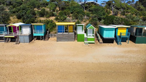 A row of beach houses on a sunny day on an Australian beach, seen from above