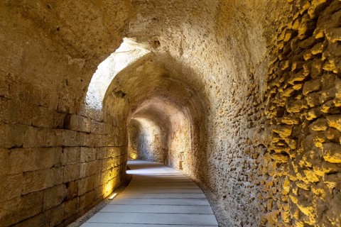 An old historic theatre in the middle of a city. Access tunnel to seats. The ruin was uncovered,