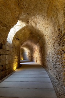 An old historic theatre in the middle of a city. Access tunnel to seats. The ruin was uncovered,