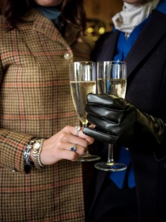 Members of the Toronto North York Hunt Club, dressed in traditional hunting clothes, enjoy a glass