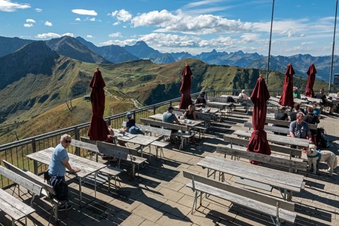 Terrace of the restaurant Gipfelstation Fellhornbahn, behind mountains of the Allgäu Alps,