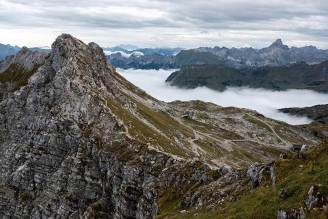 View from the Nebelhorn summit to mountains of the Allgäu Alps, mountains rise from fog in the