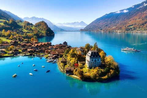 Aerial view of the village of Iseltwald on Lake Brienz in autumn, view of Seeburg Castle and course