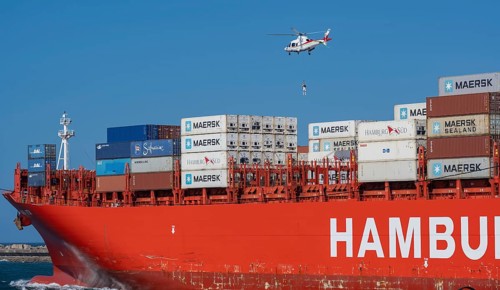 Container ship from the shipping company Hamburg Süd Santa Rita with container and helicopter to