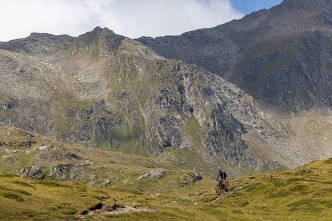 Mountain biker on the trail downhill at Passo del Sole, Olivone, Tessin, Switzerland