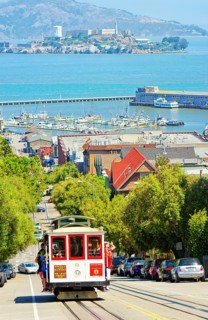 Powell-Hyde line cable car with Alcatraz Island in the background, San Francisco, California, USA