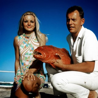 Couple posing with a trout grouper (Plectropomus pessuliferus), Red Sea, 1960s, Egypt