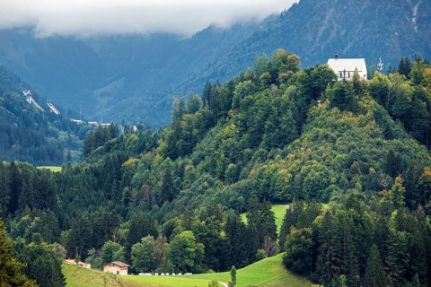 Schöllanger Castle Church, back left ski jumping hills of the Orlen Arena in Oberstdorf,