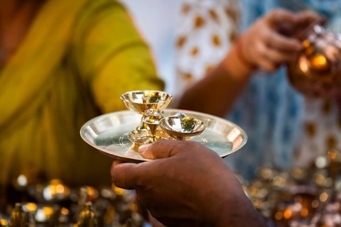 People shop for bronze and other metal items at a roadside stall on Dhanteras, in Guwahati, Assam,