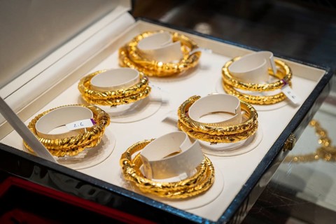 Customers purchase Gold jewelry at a store on the occasion of the festival of Dhanteras, in