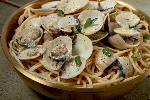 Spaghetti with vongole clams, in cream sauce, carbonara, in a brass pan, homemade, top view, no
