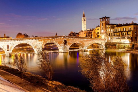 Ponte Pietra (Stone Bridge) over Adige River at evening, built by the Romans in 100 BC. Verona,