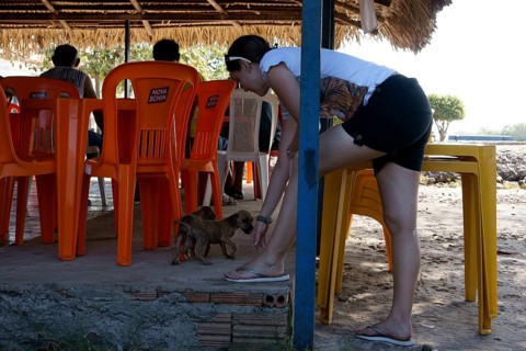 Woman Playing with Dog, Alcântara, Maranhão, Brazil