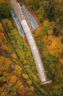Aerial view of a railway tunnel in a landscape surrounded by autumn trees, Hermann-Hesse-Bahn