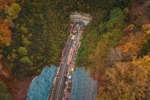 Railway system with construction under tunnel construction in autumn surroundings,