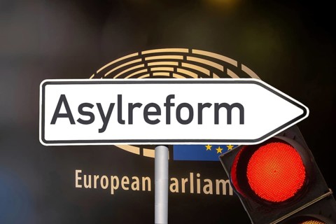 (photo montage) Directional arrow with the inscription ASYLUM REFORM in front of the European Union